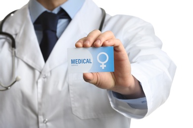 Photo of Gynecologist holding business card isolated on white, closeup. Medical service