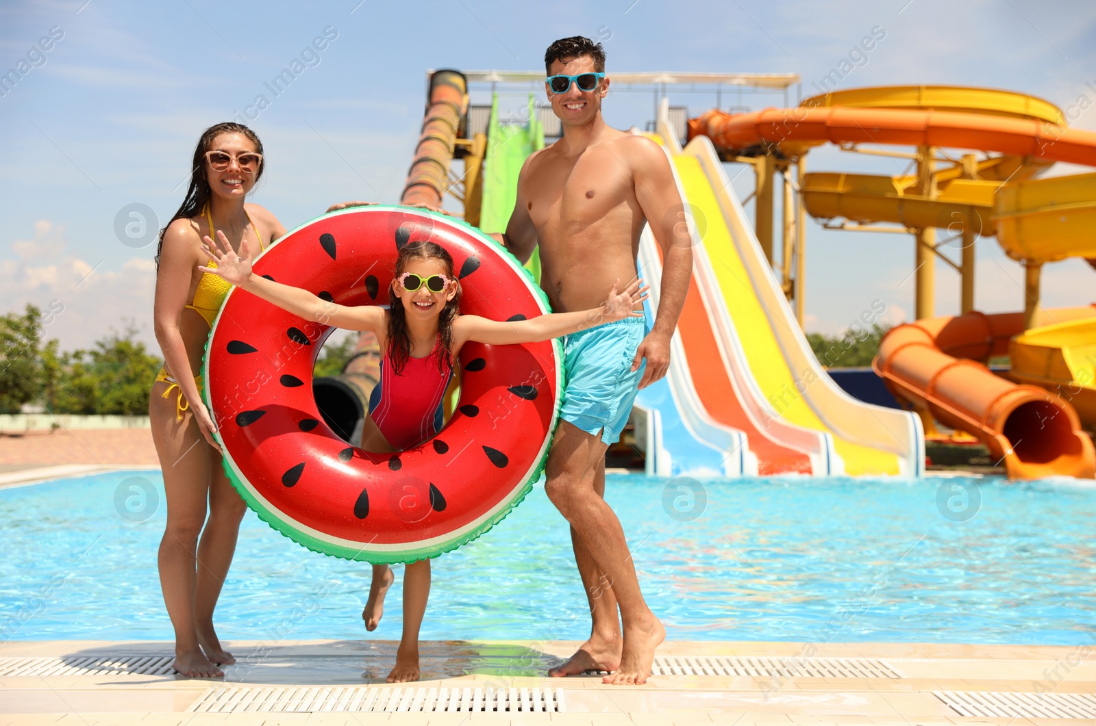 Photo of Happy family at water park. Summer vacation