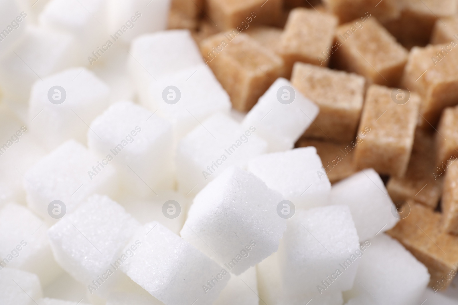 Photo of White and brown sugar cubes as background, closeup