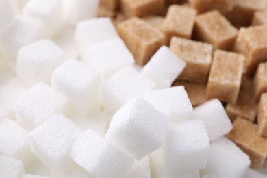 Photo of White and brown sugar cubes as background, closeup