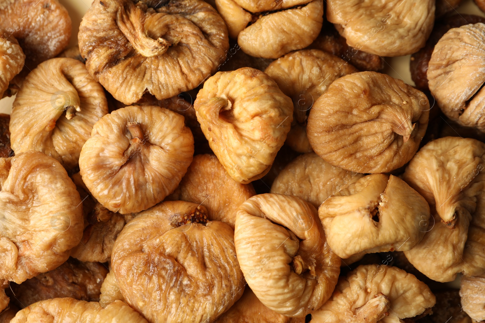 Photo of Many tasty dried figs as background, top view