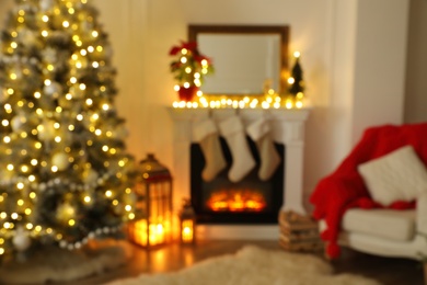 Photo of Blurred view of fireplace in living room decorated for Christmas