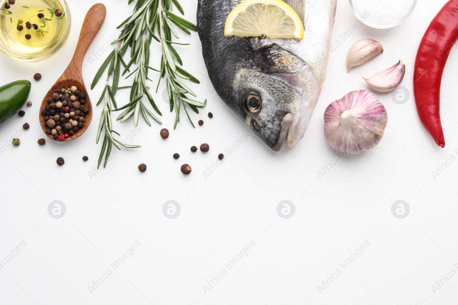 Photo of Flat lay composition with fresh raw dorado fish and ingredients on white table, space for text