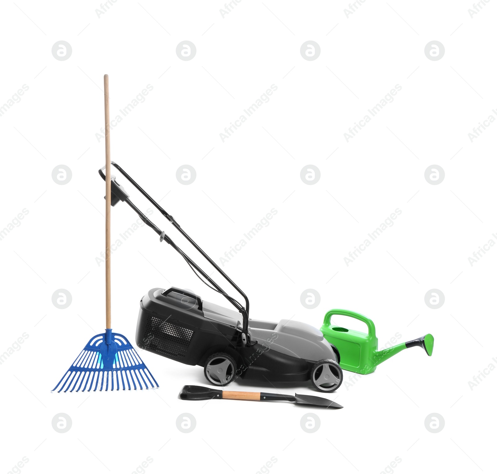 Photo of Modern electric grass cutter and gardening tools on white background