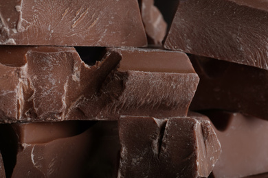 Photo of Pieces of milk chocolate as background, closeup