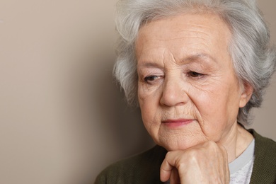 Photo of Portrait of mature woman on color background. Space for text