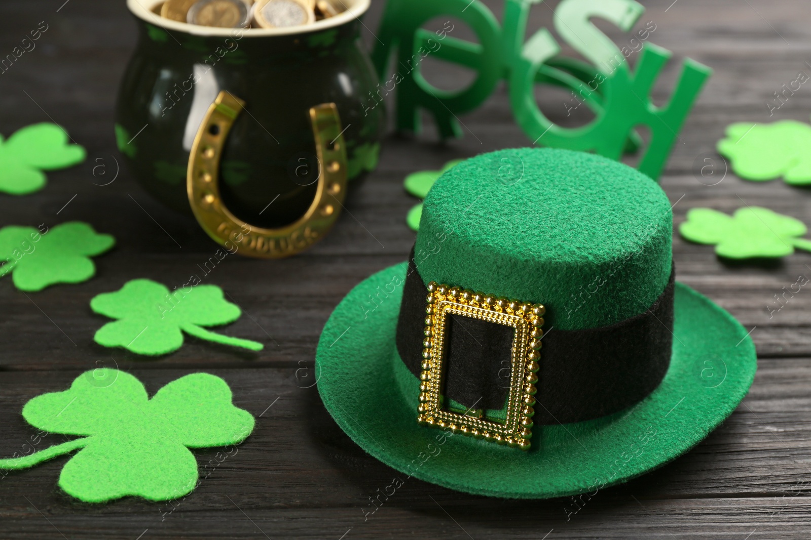 Photo of Leprechaun's hat and St. Patrick's day decor on black wooden table