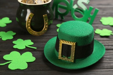 Leprechaun's hat and St. Patrick's day decor on black wooden table
