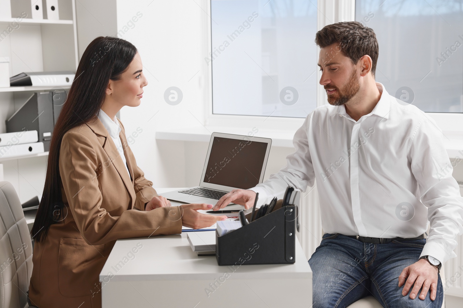 Photo of Human resources manager conducting job interview with applicant in office