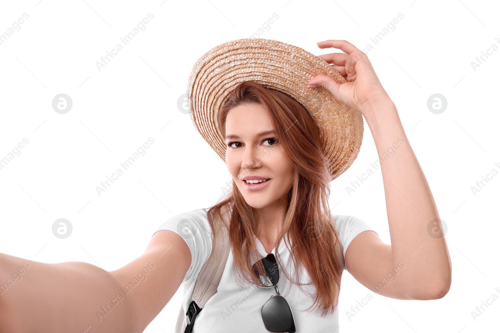 Photo of Beautiful woman in straw hat taking selfie on white background