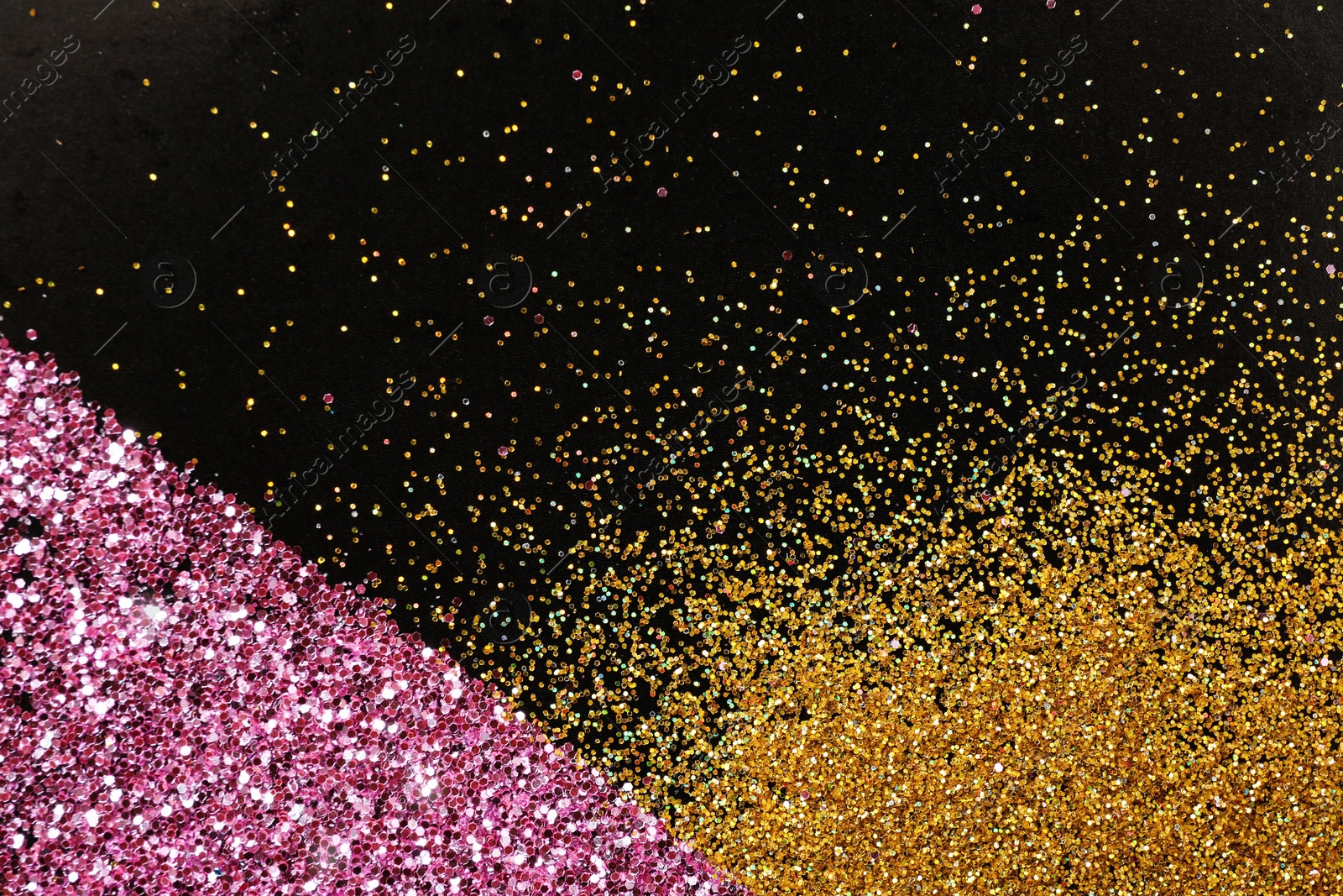 Photo of Gold and rose glitter on black background, top view with space for text