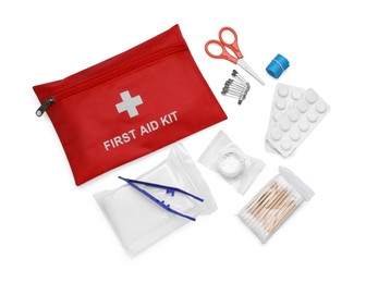 Photo of Red first aid kit, scissors, pins, cotton buds, pills, plastic forceps, adhesive plaster and elastic bandage isolated on white, top view