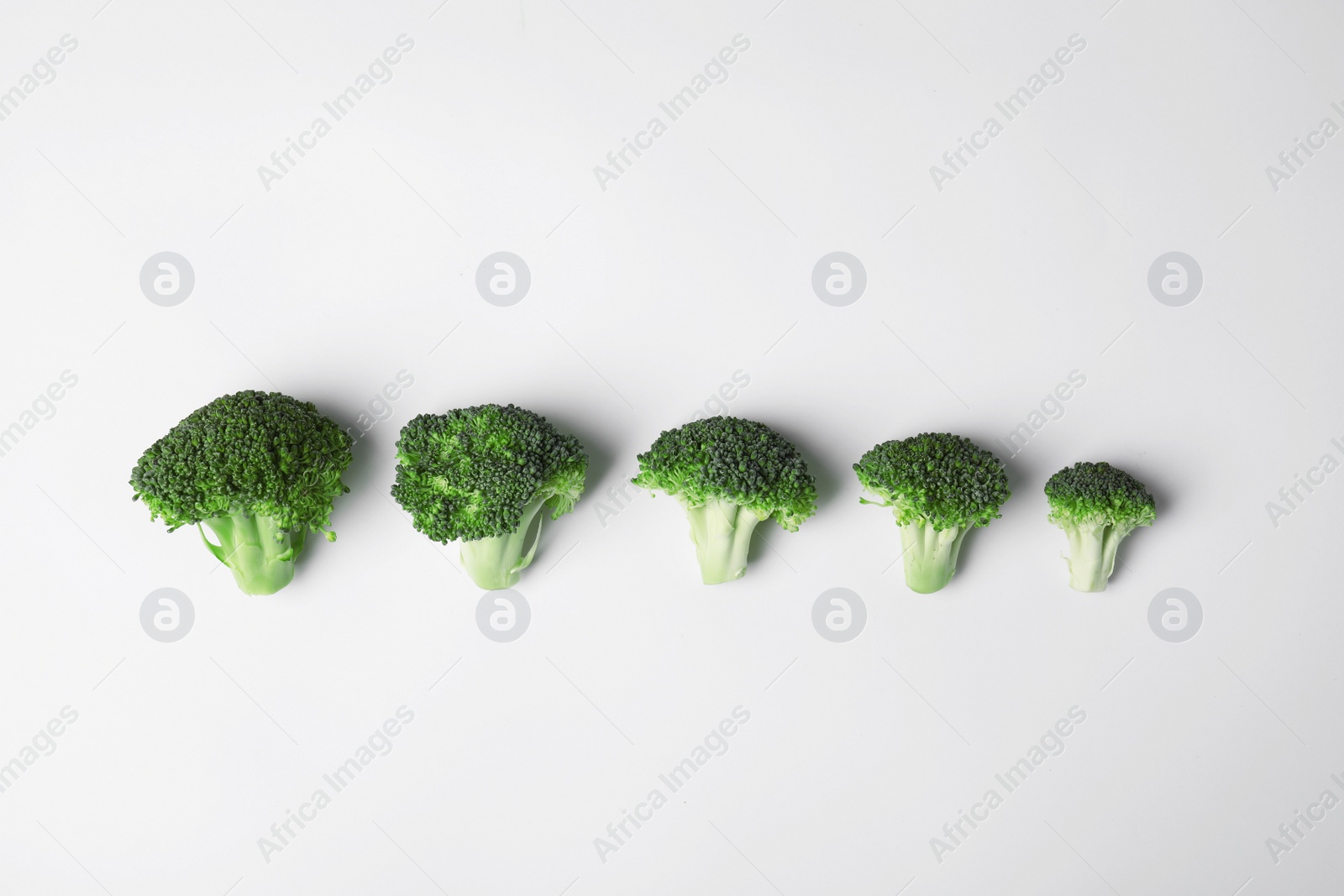 Photo of Flat lay composition with fresh green broccoli on light background