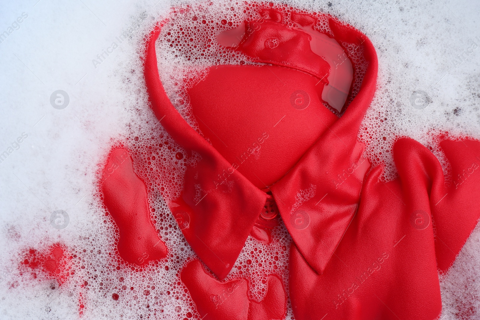 Photo of Color clothing in suds, top view. Hand washing laundry