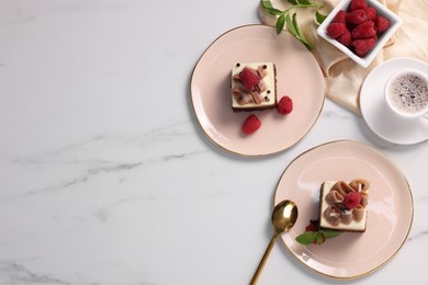 Pieces of triple chocolate mousse cake with raspberries served on white marble table, flat lay. Space for text