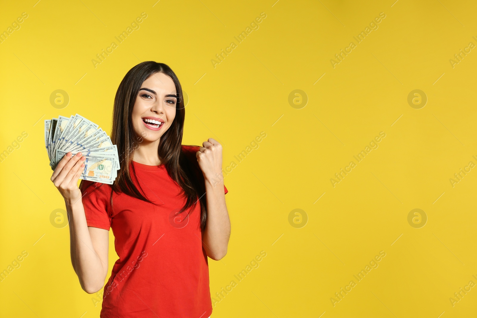 Photo of Young woman with money on color background. Space for text