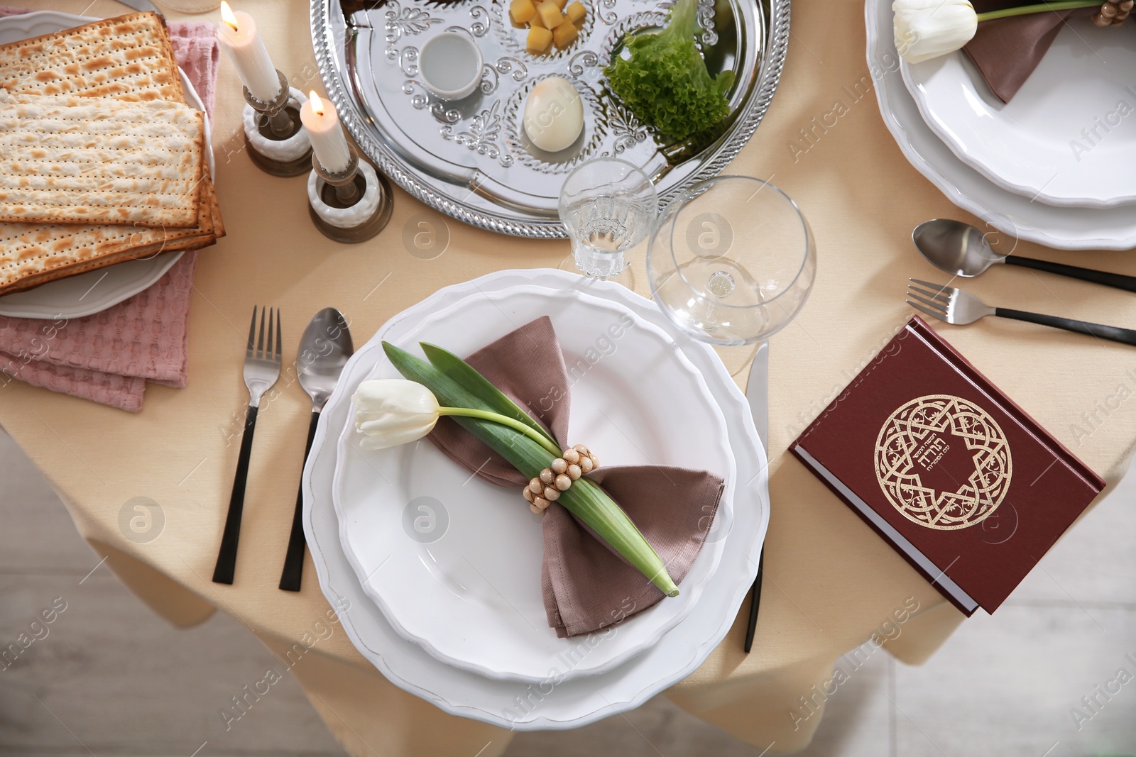 Photo of Festive Passover table setting with Torah, top view. Pesach celebration