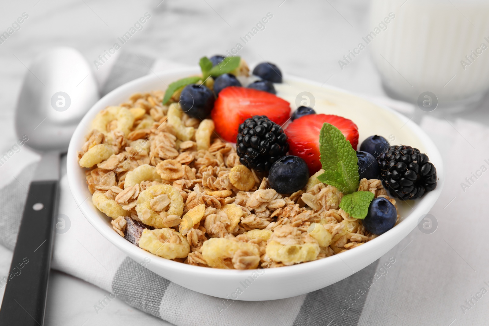 Photo of Tasty oatmeal, yogurt and fresh berries in bowl on table, closeup. Healthy breakfast