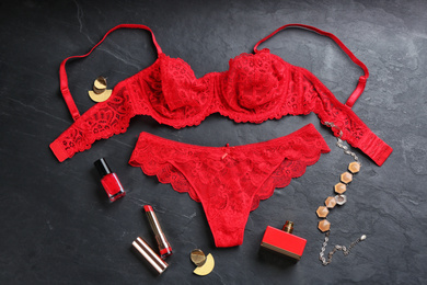 Photo of Flat lay composition with women's underwear on black stone background