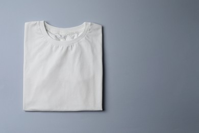 Stylish T-shirt on light grey background, top view. Space for text