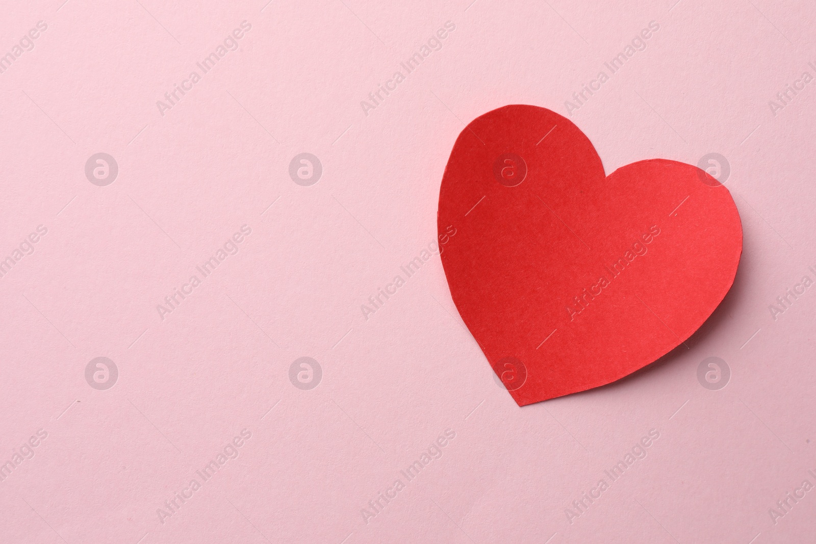 Photo of One paper heart on pink background, top view. Space for text