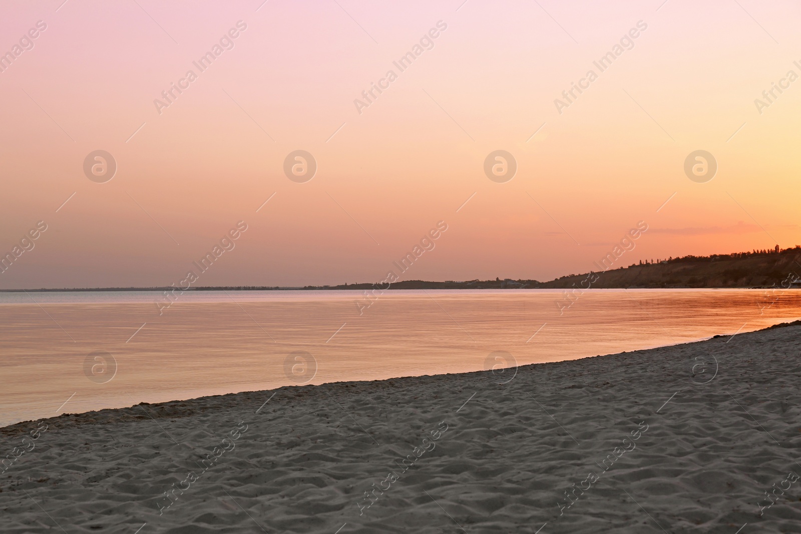 Photo of Sandy beach near sea at summer sunset