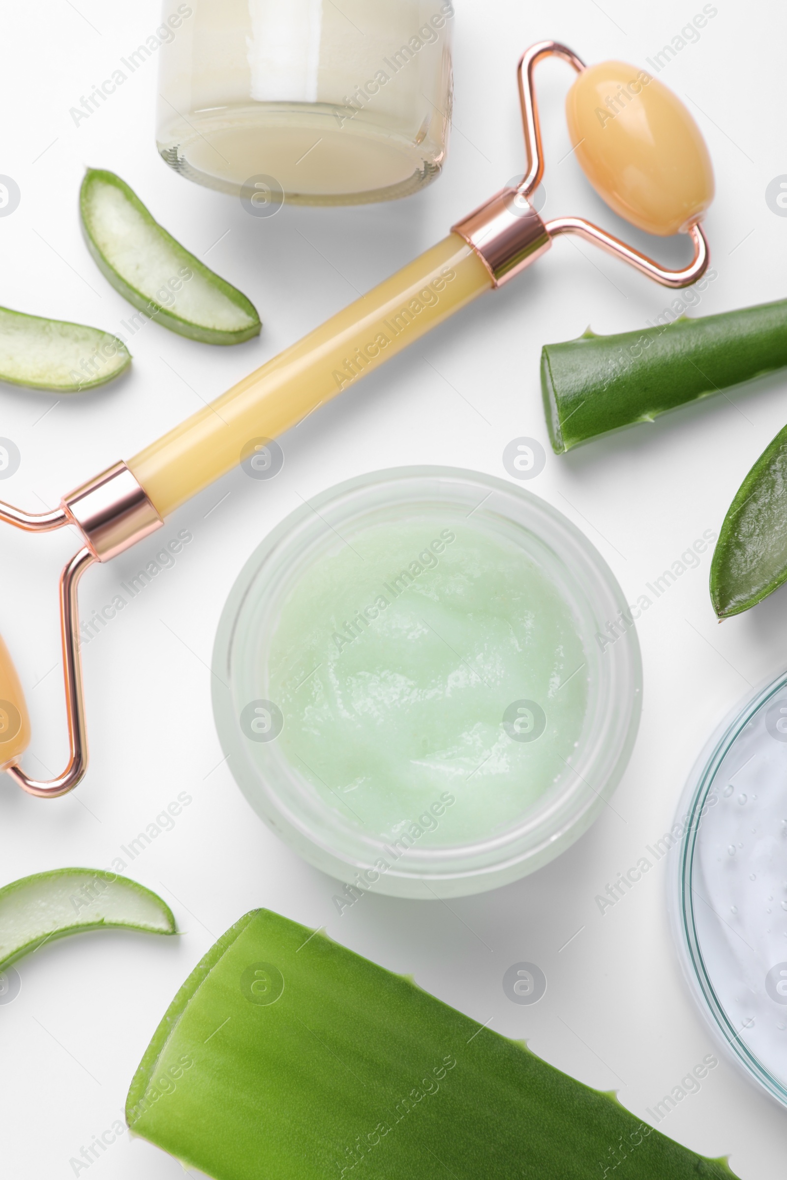 Photo of Flat lay composition with cosmetic products and cut aloe leaves on white background