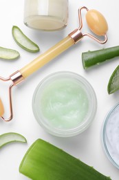 Flat lay composition with cosmetic products and cut aloe leaves on white background