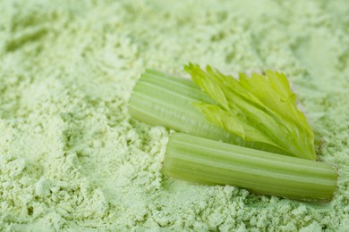 Photo of Fresh stalks on natural celery powder, closeup. Space for text
