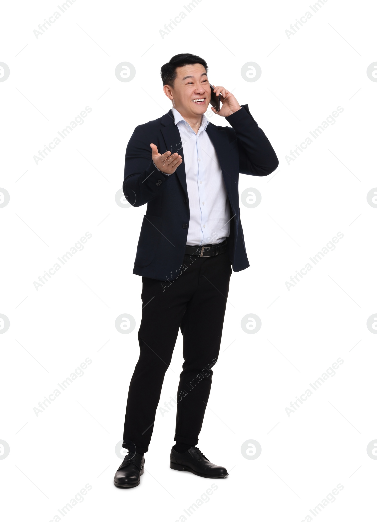 Photo of Businessman in suit talking on phone against white background