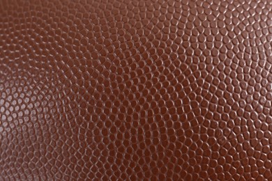 Photo of Texture of American football ball leather as background, closeup