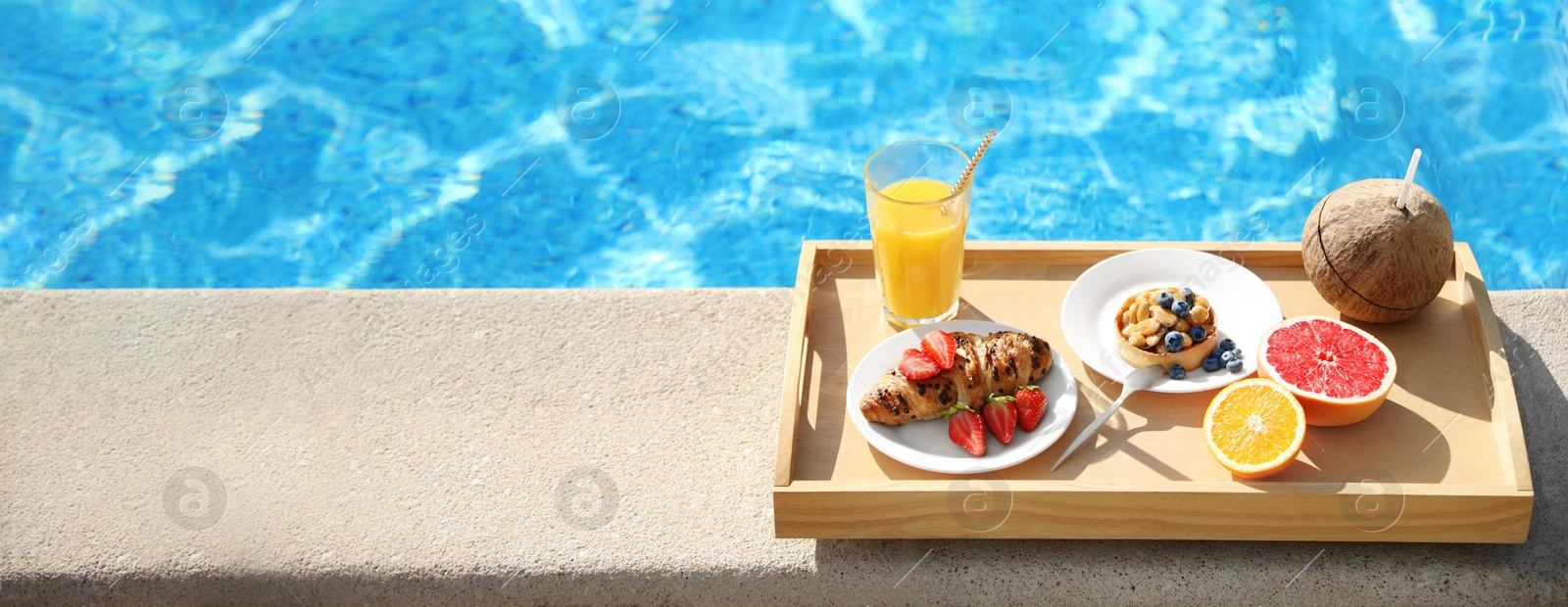 Image of Tray with delicious breakfast near swimming pool, space for text. Banner design