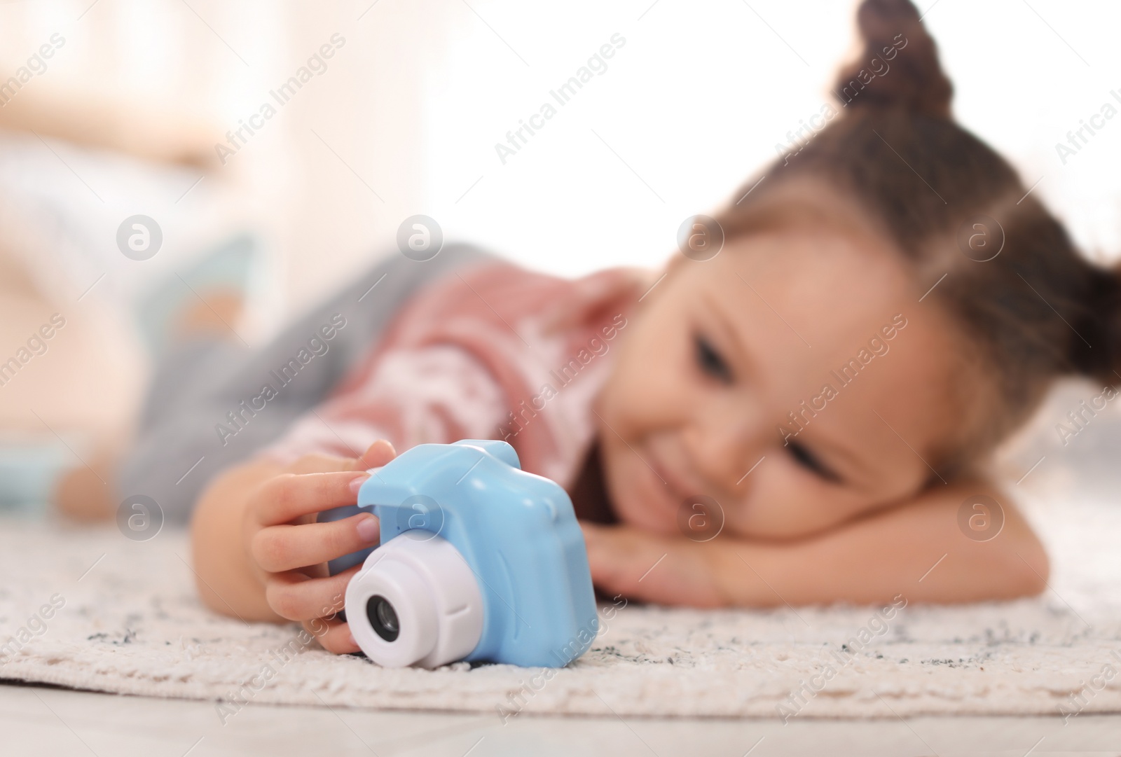 Photo of Little photographer indoors, focus on hand with camera