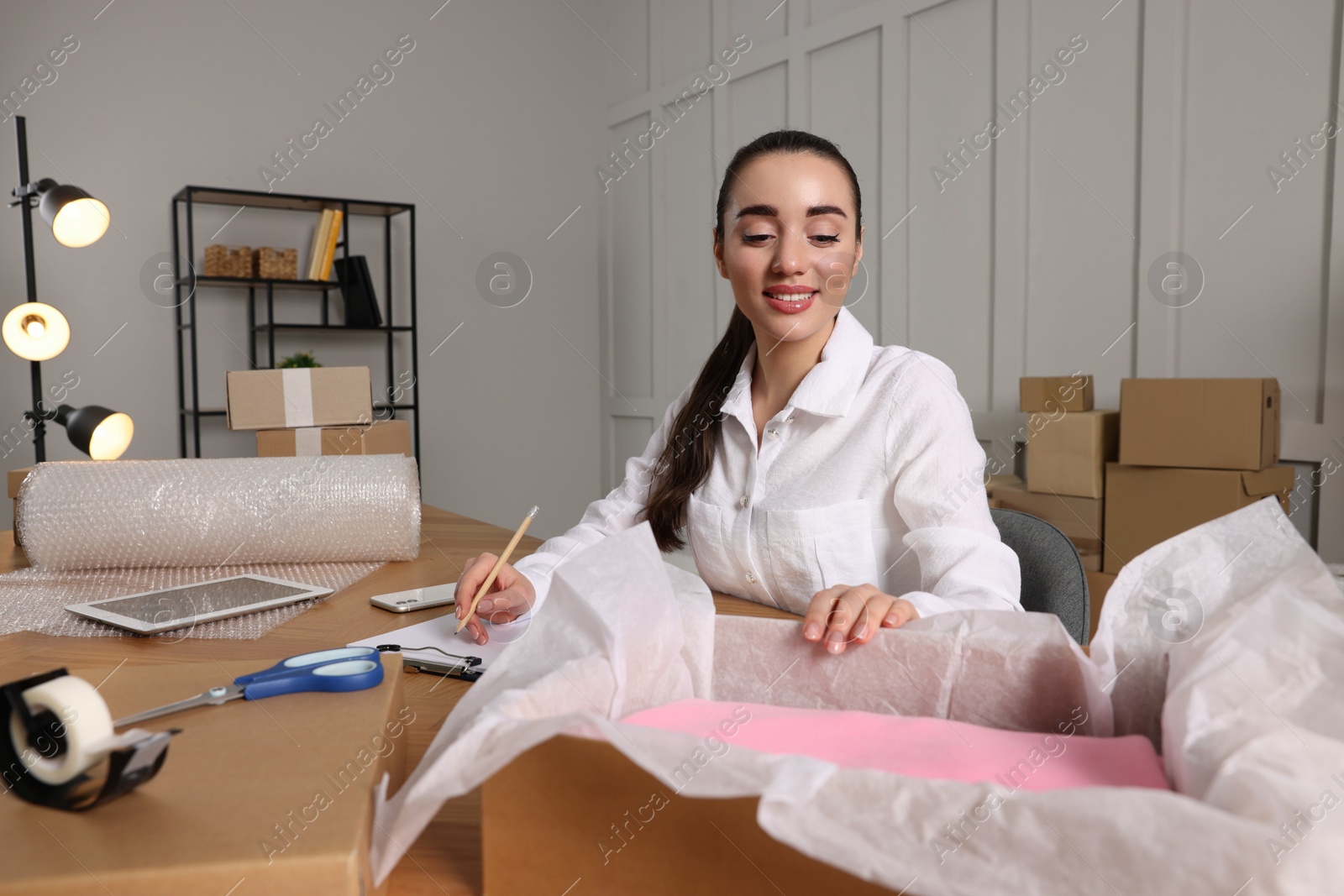 Photo of Seller working at table in office. Online store