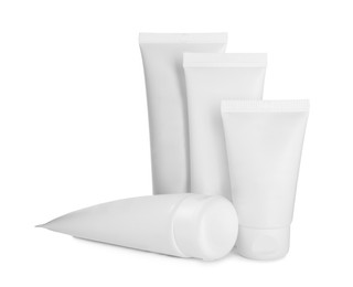 Photo of Blank tubes of cosmetic products on white background