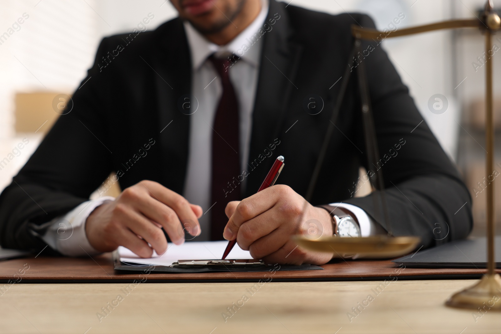 Photo of Lawyer working at table in office, closeup