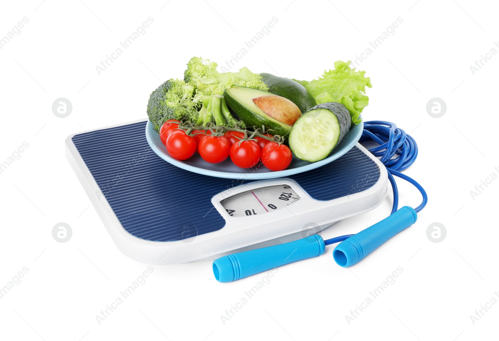 Photo of Skipping rope and bowl with different vegetables on scales isolated on white. Weight loss concept