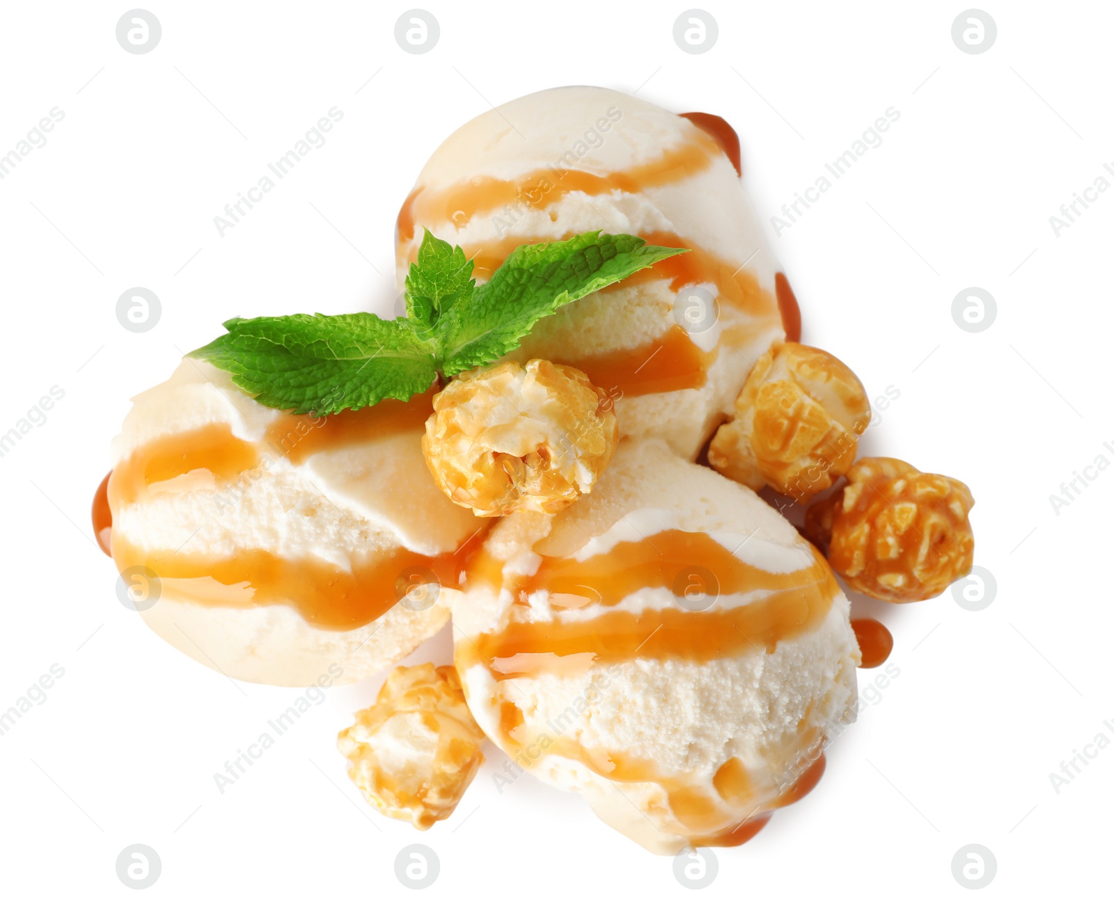 Photo of Scoops of delicious ice cream with mint, caramel sauce and popcorn on white background, top view