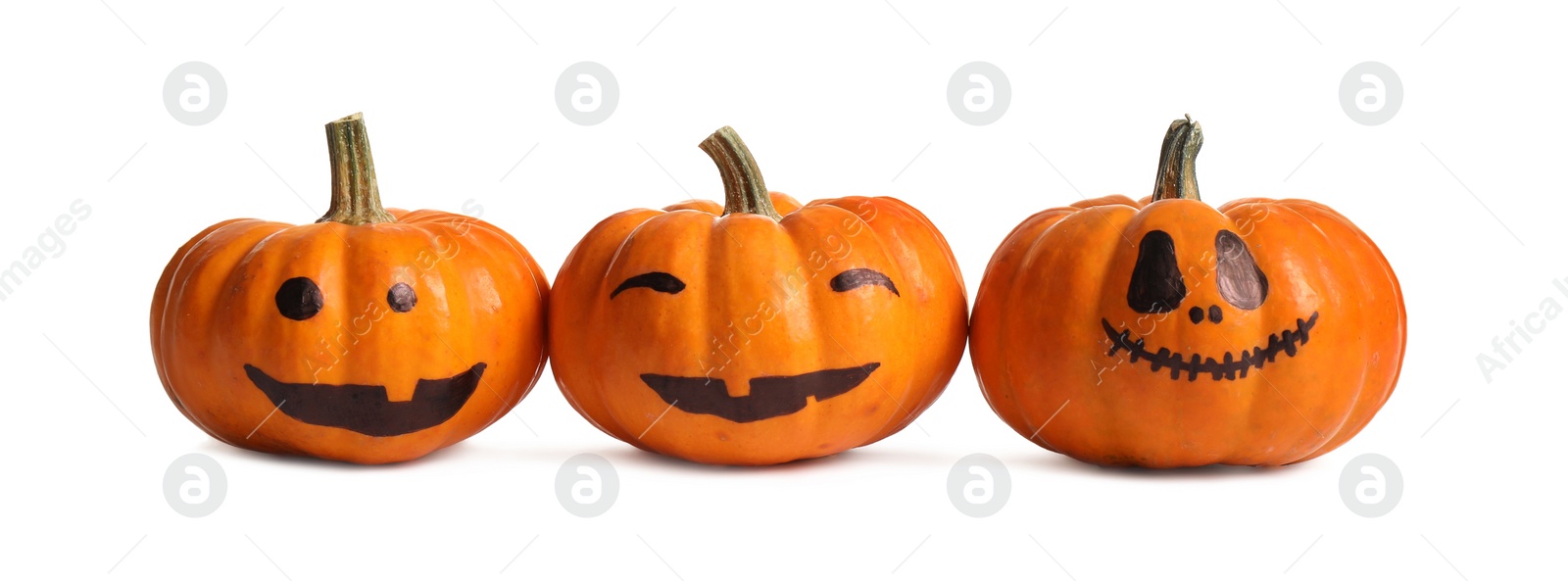 Photo of Halloween pumpkins with cute drawn faces on white background