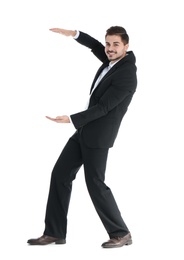 Photo of Young businessman with magnet attracting people on white background