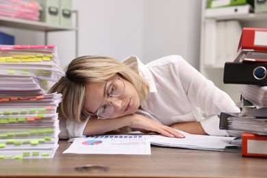 Office worker sleeping at workplace. Overwhelmed by work