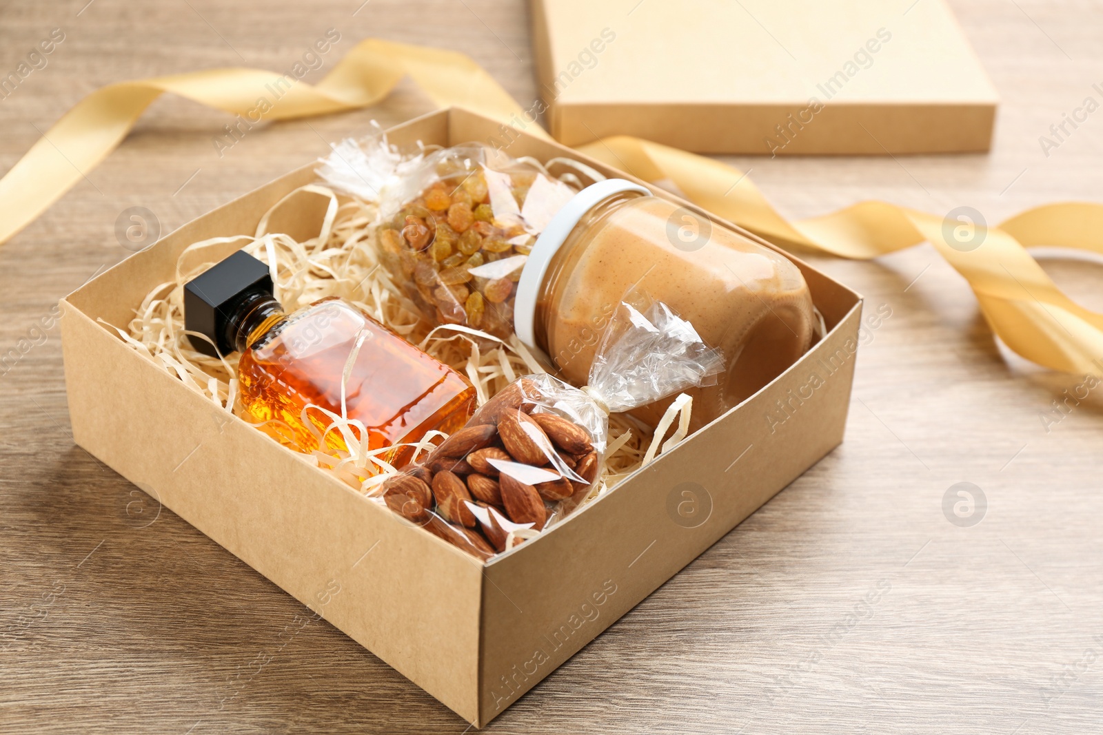 Photo of Stylish gift set in box on wooden table