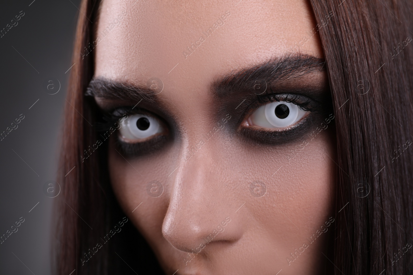 Photo of Mysterious witch with spooky eyes, closeup. Halloween party