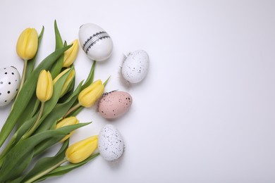 Photo of Beautiful tulips and eggs on white background, flat lay with space for text. Easter celebration