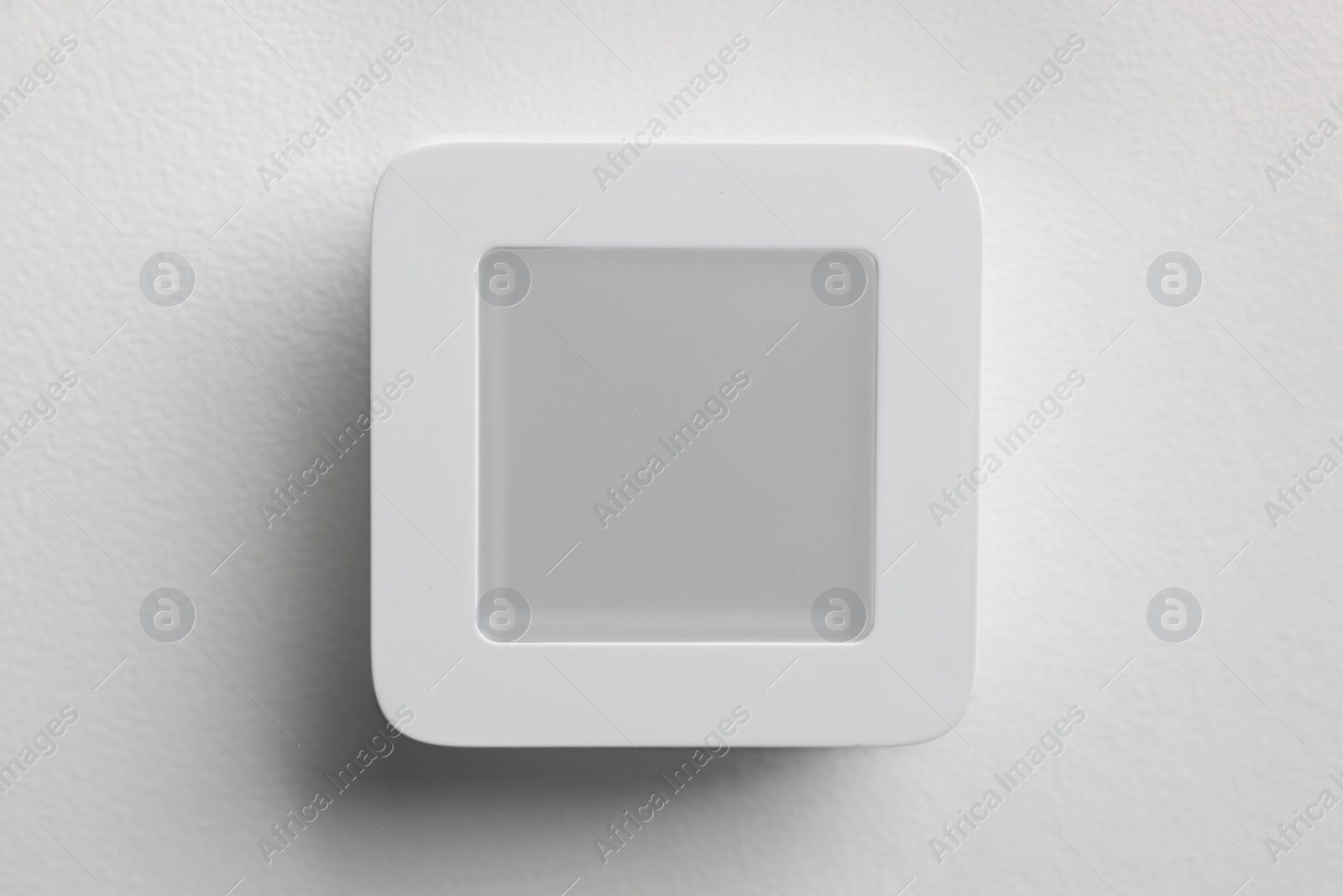 Photo of One thermostat on white wall. Smart home system