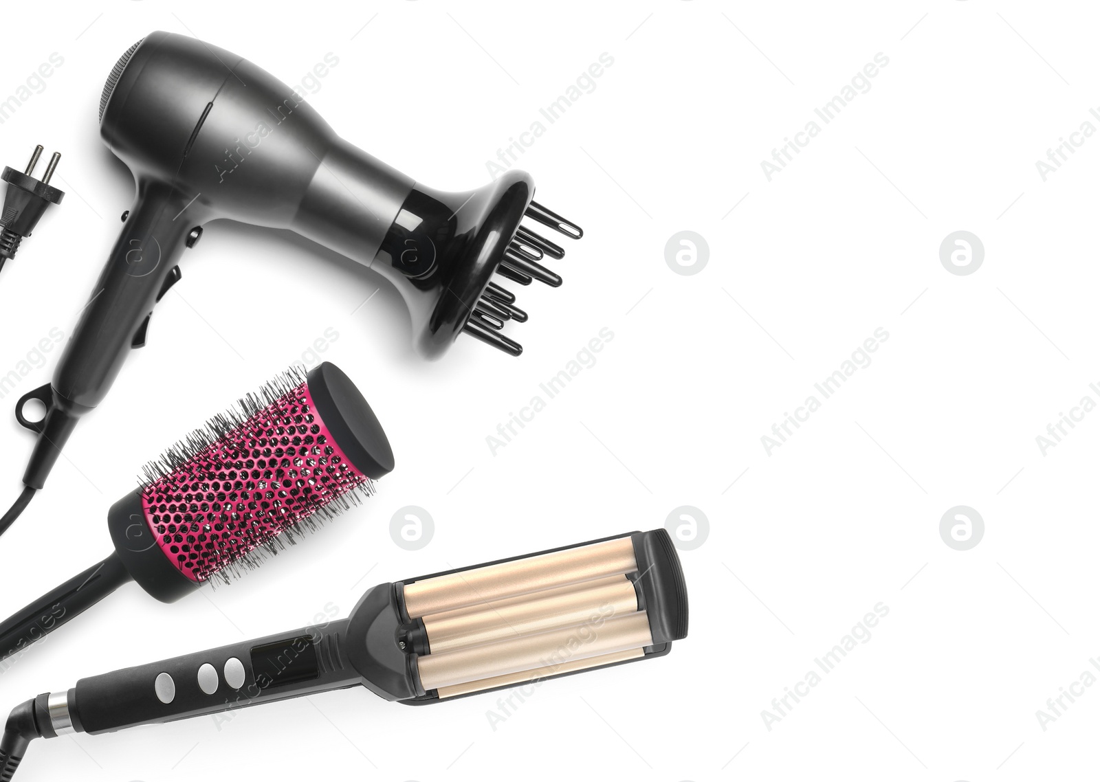 Image of Hair dryer, round brush and triple curling iron on white background, top view