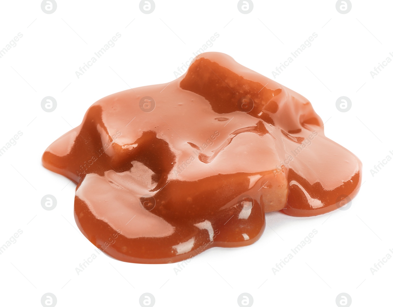 Photo of Caramel candies under tasty sauce isolated on white
