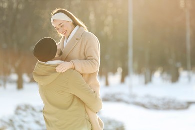 Beautiful young couple enjoying winter day outdoors