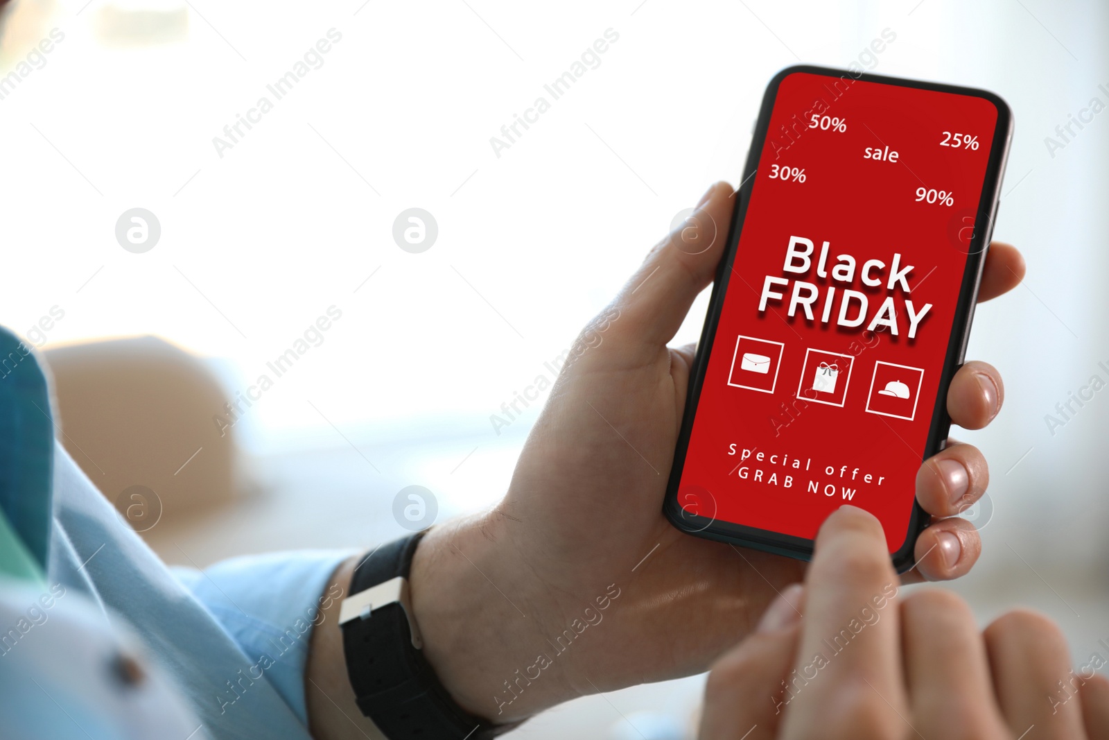 Image of Black Friday. Man shopping online using smartphone, closeup