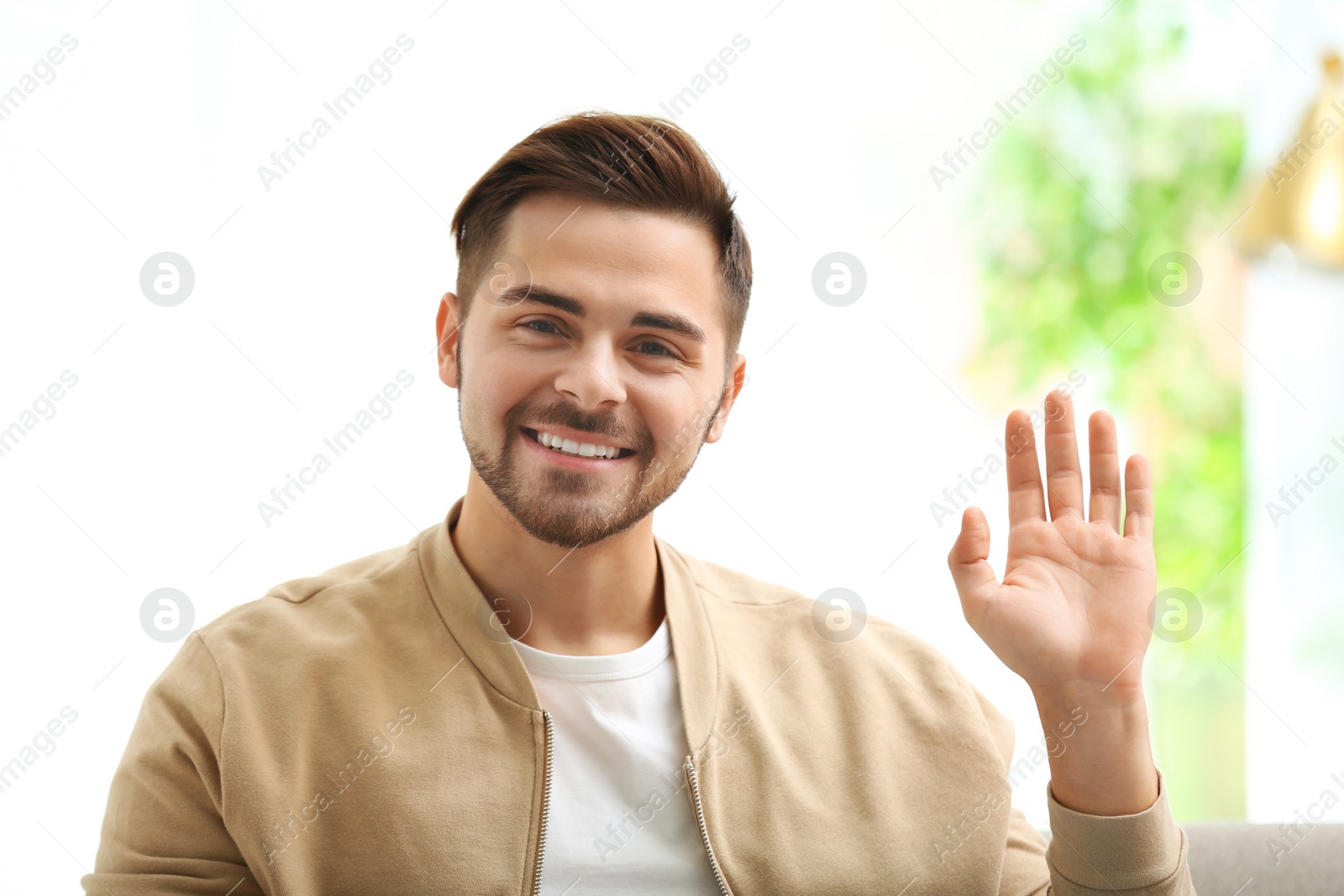 Photo of Handsome man using video chat for conversation indoors